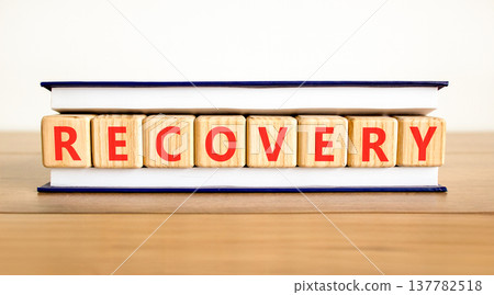 Recovery word symbol. Concept word Recovery on beautiful wooden blocks in beautiful book. Beautiful wooden table white background. Business medical support help recovery word concept. Copy space. Recovery word symbol. Concept word Recovery on beautiful wooden blocks in beautiful book. Beautiful wooden table white background. Business medical support help recovery word concept. Copy space. 137782518