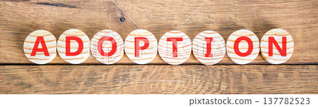 Adoption word symbol. Concept word Adoption on beautiful wooden circles. Beautiful wooden background. Business psychological support help adoption word concept. Copy space. 137782523