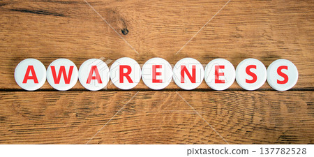 Awareness symbol. Concept word Awareness on beautiful white circles. Beautiful wooden background. Business education awareness concept. Copy space. Awareness symbol. Concept word Awareness on beautiful white circles. Beautiful wooden background. Business education awareness concept. Copy space. 137782528