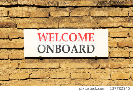 Welcome onboard symbol. Concept words Welcome onboard on beautiful big white sign plate. Beautiful old brown brick wall background. Business, motivational welcome onboard concept. Copy space. 137782540