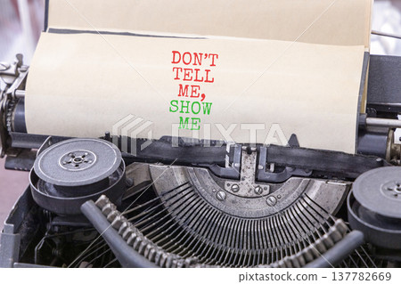 Tell or show symbol. Concept words Do not tell me, show me typed on old retro typewriter. Beautiful white background. Business tell or show concept. Copy space. 137782669