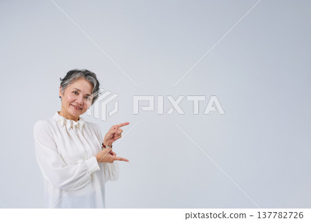 Senior women posing as if giving directions or making suggestions. Senior women posing as if giving directions or making suggestions. 137782726