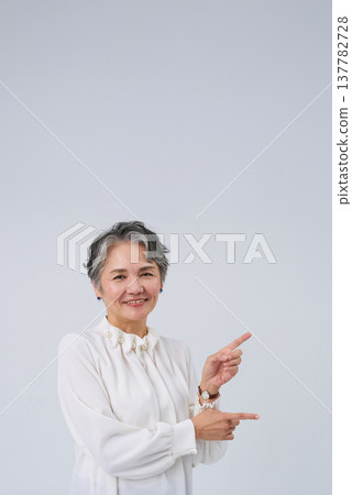 Senior women posing as if giving directions or making suggestions. Senior women posing as if giving directions or making suggestions. 137782728