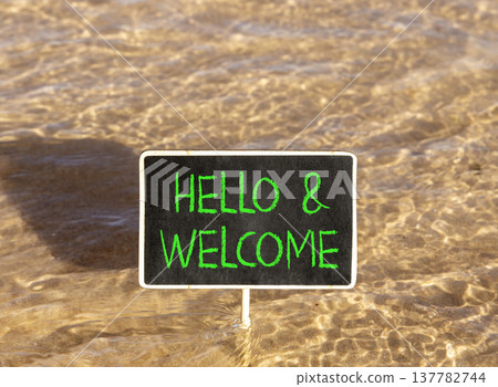 Hello and welcome symbol. Concept words Hello and welcome on beautiful black blackboard. Beautiful Red sea water background. Business hello and welcome concept. Copy space. Hello and welcome symbol. Concept words Hello and welcome on beautiful black blackboard. Beautiful Red sea water background. Business hello and welcome concept. Copy space. 137782744