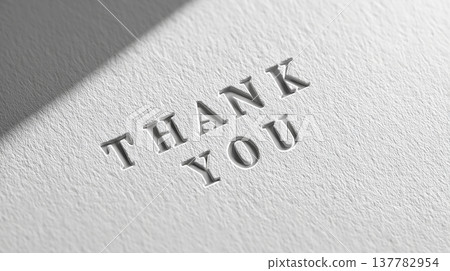 Thank you message on textured paper with light and shadows creating depth Thank you message on textured paper with light and shadows creating depth 137782954