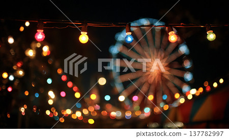 Fairground lights shine bright at night with a colorful ferris wheel in the background during a festive celebration Fairground lights shine bright at night with a colorful ferris wheel in the background during a festive celebration 137782997