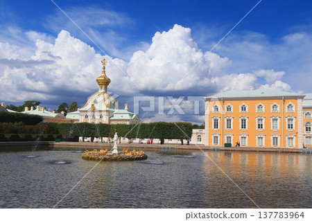 Russia, St. Petersburg, Peterhof, July 8, 2019. In the photo - the main court temple with a double-headed eagle on the dome in the Upper Park of the State Museum Reserve "Petergof" and people who walk 137783964
