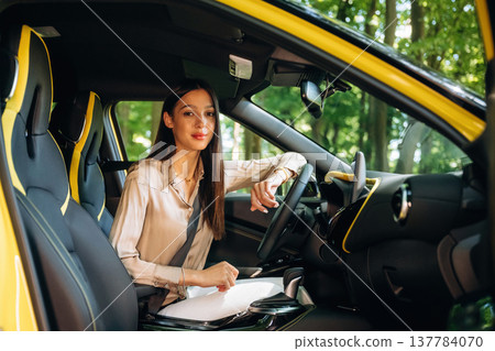 Safety first, with belt. Woman is with her car in the forest 137784070