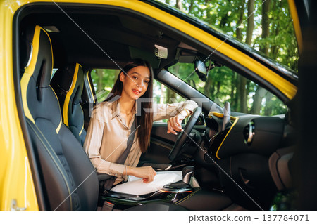 Safety first, with belt. Woman is with her car in the forest Safety first, with belt. Woman is with her car in the forest 137784071