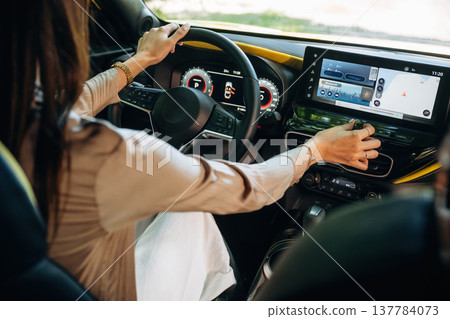 Interior of modern car. Young woman is sitting in it Interior of modern car. Young woman is sitting in it 137784073