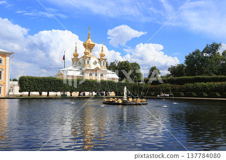 Russia, St. Petersburg, Peterhof, July 8, 2019. On the photo is the main court church in the Upper Park of the State Museum Reserve "Peterhof" and people who walk in the park and admire the 137784080