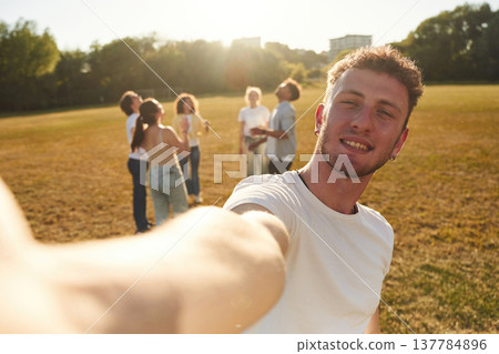 Modern style, selfie time. Young friends are having fun on the field Modern style, selfie time. Young friends are having fun on the field 137784896