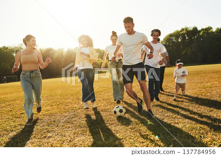 Hobby of sport. Group of friends are playing soccer on the field Hobby of sport. Group of friends are playing soccer on the field 137784956