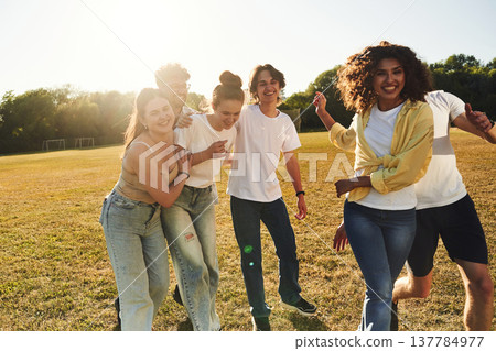 Going crazy, having fun. Young friends are on the field Going crazy, having fun. Young friends are on the field 137784977