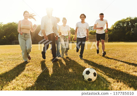 Group of friends are playing soccer on the field 137785010