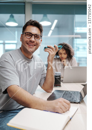 Professional Enjoying Coffee Break. Person Smiling And Resting With Coffee Beside Work Tools And Colleague Professional Enjoying Coffee Break. Person Smiling And Resting With Coffee Beside Work Tools And Colleague 137785042