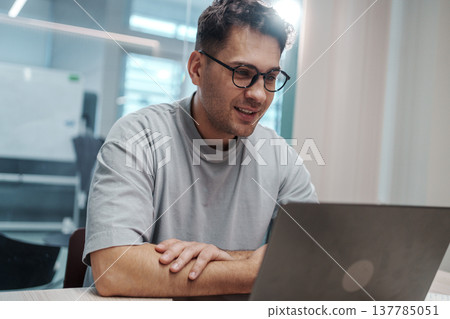 White Man Reviews Mockup Thoughtfully. Focused Caucasian Male Analyzes Design Layout On His Laptop White Man Reviews Mockup Thoughtfully. Focused Caucasian Male Analyzes Design Layout On His Laptop 137785051