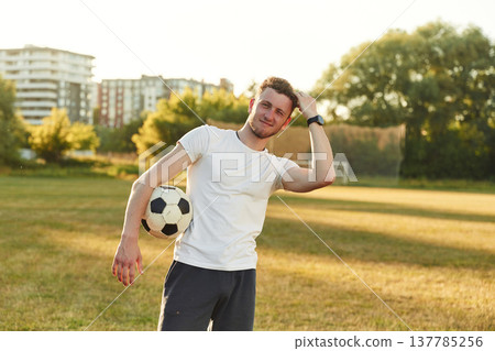 Man is in the field with soccer ball Man is in the field with soccer ball 137785256