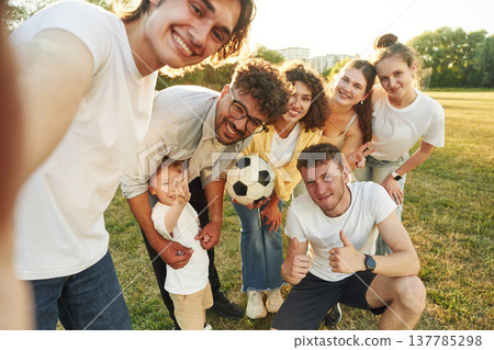 Selfie time, smiling. Young friends are having fun on the field with soccer ball Selfie time, smiling. Young friends are having fun on the field with soccer ball 137785298