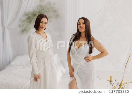 Two beautiful women in long dresses in the studio 137785880