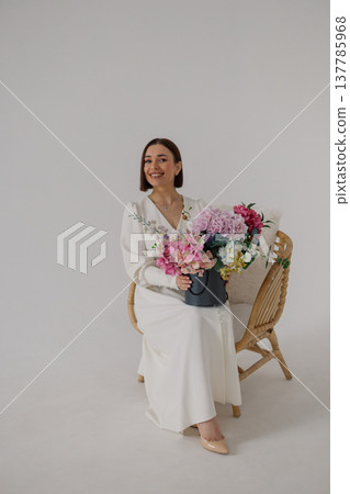 Young beautiful woman posing on a beautiful chair 137785968