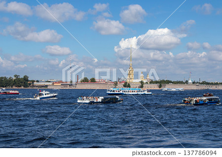 Saint Petersburg,Russia, July 8, 2020, Peter and Paul fortress. In the photo, Peter and Paul fortress and boats with tourists, view from the Palace embankment Saint Petersburg,Russia, July 8, 2020, Peter and Paul fortress. In the photo, Peter and Paul fortress and boats with tourists, view from the Palace embankment 137786094