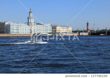 Russia, Petersburg, June 8, 2019. Spit of Vasilyevsky Island. The photo of the Rostral Column and the Kuntskamera building on the bank of the Neva against the sky Russia, Petersburg, June 8, 2019. Spit of Vasilyevsky Island. The photo of the Rostral Column and the Kuntskamera building on the bank of the Neva against the sky 137786100