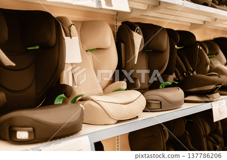 Car seats are arranged neatly on display shelves in a retail store. Parents can explore various designs and features while shopping for child safety products Car seats are arranged neatly on display shelves in a retail store. Parents can explore various designs and features while shopping for child safety products 137786206