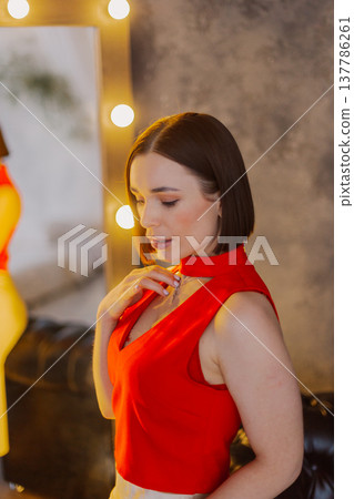 Young beautiful woman posing near mirror with 137786261