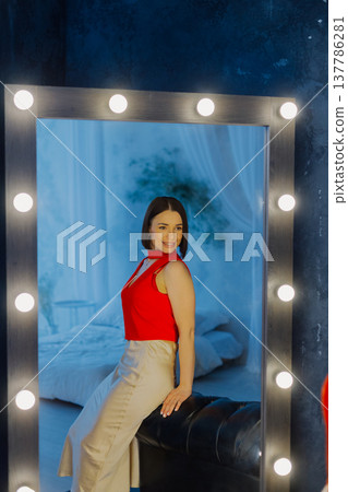 Young beautiful woman posing on leather sofa near Young beautiful woman posing on leather sofa near 137786281