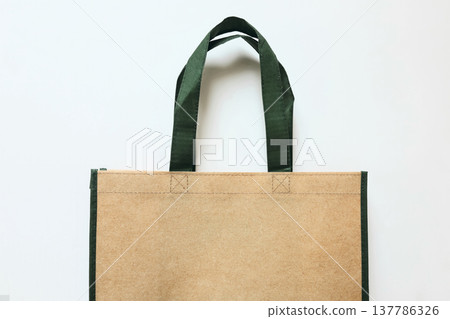 Reusable Shopping Tote Bag Mockup with Green Handles Isolated on White Background. Eco Recycled Friendly Grocery Bag for Sustainable Shopping. Branding Shopping Product Template, copy space 137786326