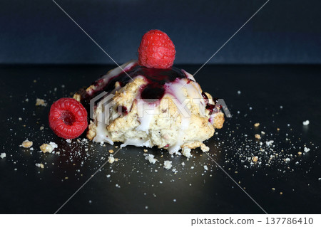 Scones with raspberry jam and lemon glaze on top Scones with raspberry jam and lemon glaze on top 137786410