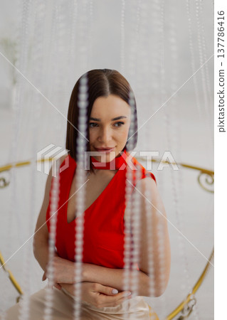 Young beautiful woman posing near gilded crystal Young beautiful woman posing near gilded crystal 137786416
