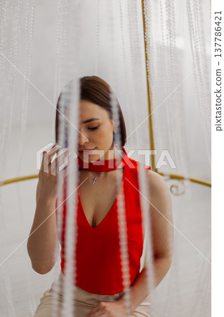 Young beautiful woman posing near gilded crystal Young beautiful woman posing near gilded crystal 137786421