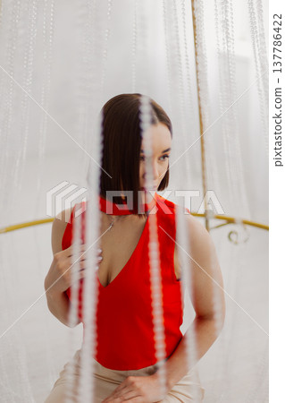 Young beautiful woman posing near gilded crystal Young beautiful woman posing near gilded crystal 137786422