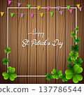 Happy St. Patrick's Day with clover leaves above wooden background 137786544
