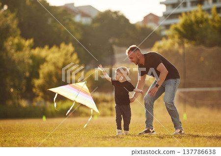 Active weekend, running with kite in hand. Happy father with son on the field 137786638