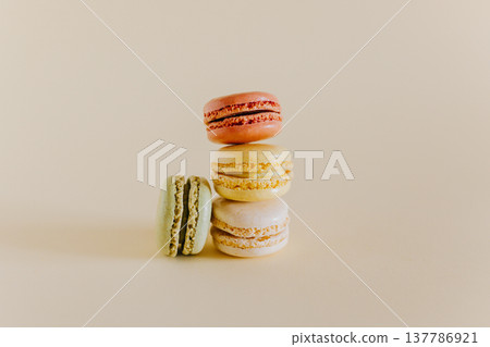 Tasty french macarons on a peach pastel background. Tasty french macarons on a peach pastel background. 137786921