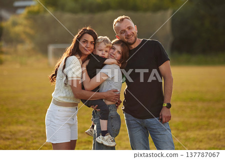 Green field, summertime. Photo of happy family with husband, wife and two kids 137787067