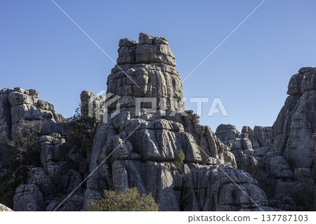 Exploring the unique rock formations at El Torcal in Spain under the clear blue sky Exploring the unique rock formations at El Torcal in Spain under the clear blue sky 137787103
