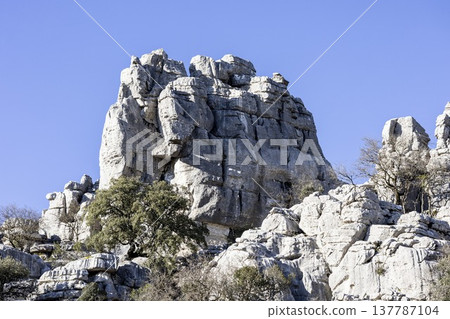 Rock formations stand tall against the blue sky at El Torcal in Spain during a sunny day 137787104