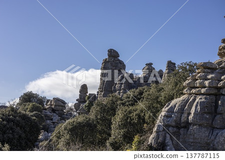 Exploring the unique rock formations of El Torcal in Spain under a clear blue sky Exploring the unique rock formations of El Torcal in Spain under a clear blue sky 137787115