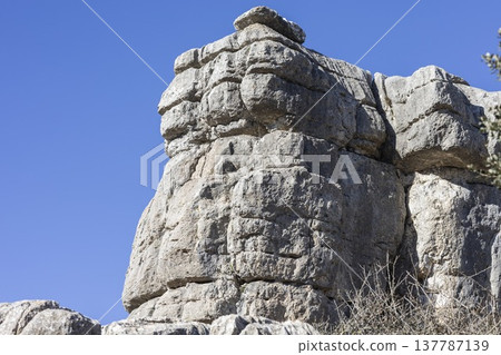 Unique rock formation located in El Torcal, Spain near the hiking trails with clear blue sky above 137787139