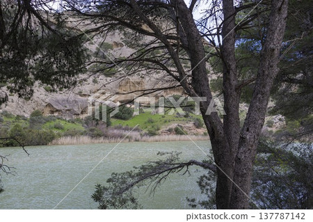Exploring Caminito del Rey in Spain with a view of the river and cliffs in the background Exploring Caminito del Rey in Spain with a view of the river and cliffs in the background 137787142