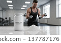Muscle Fuel supplement bottle, dumbbell workout male athlete in bright gym. Ideal for protein, fitness, health, strength, bodybuilding, sports nutrition, modern 137787176