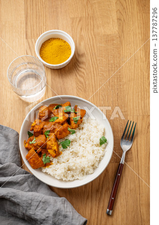 Chicken tikka masala curry with rice on wooden background Chicken tikka masala curry with rice on wooden background 137787296