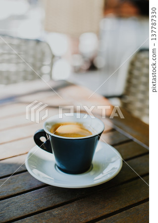 Cup of black coffee on a table in a street cafe. 137787330