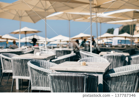 Beach cafe in a summer sunny day near the old town of Budva, Montenegro. Beach cafe in a summer sunny day near the old town of Budva, Montenegro. 137787346