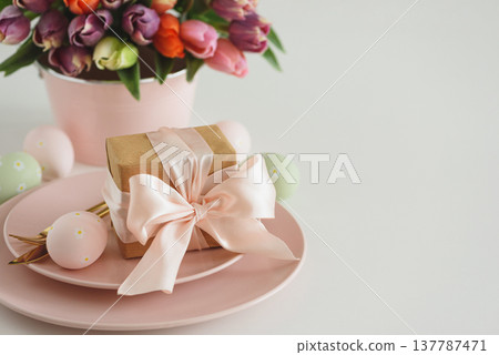 Easter Table Setting with Gift Box, Decorated Eggs and Tulips. Festive Spring Lifestyle Easter Table Setting with Gift Box, Decorated Eggs and Tulips. Festive Spring Lifestyle 137787471