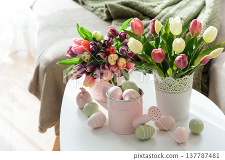 Easter Table with Tulip Bouquets, Eggs and Festive Decor. Cozy Spring Arrangement Easter Table with Tulip Bouquets, Eggs and Festive Decor. Cozy Spring Arrangement 137787481